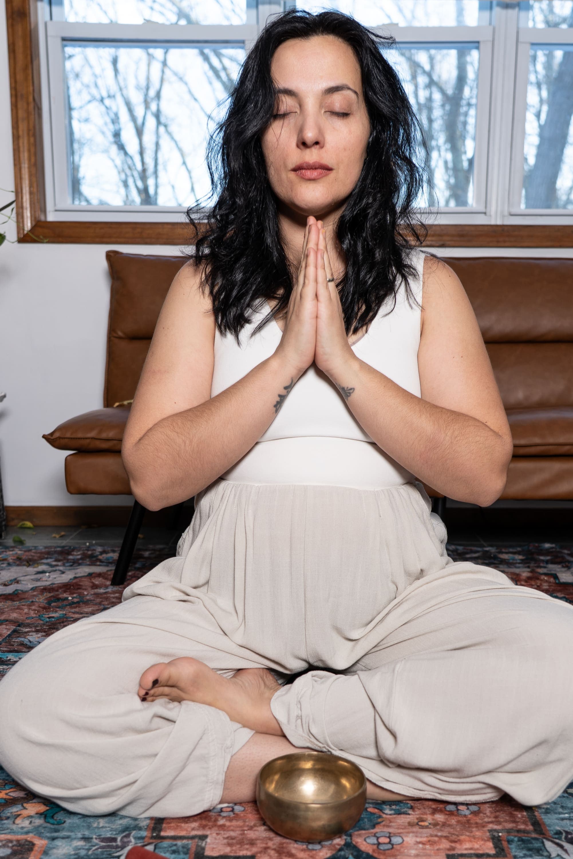 Doula meditating with a singing bowl